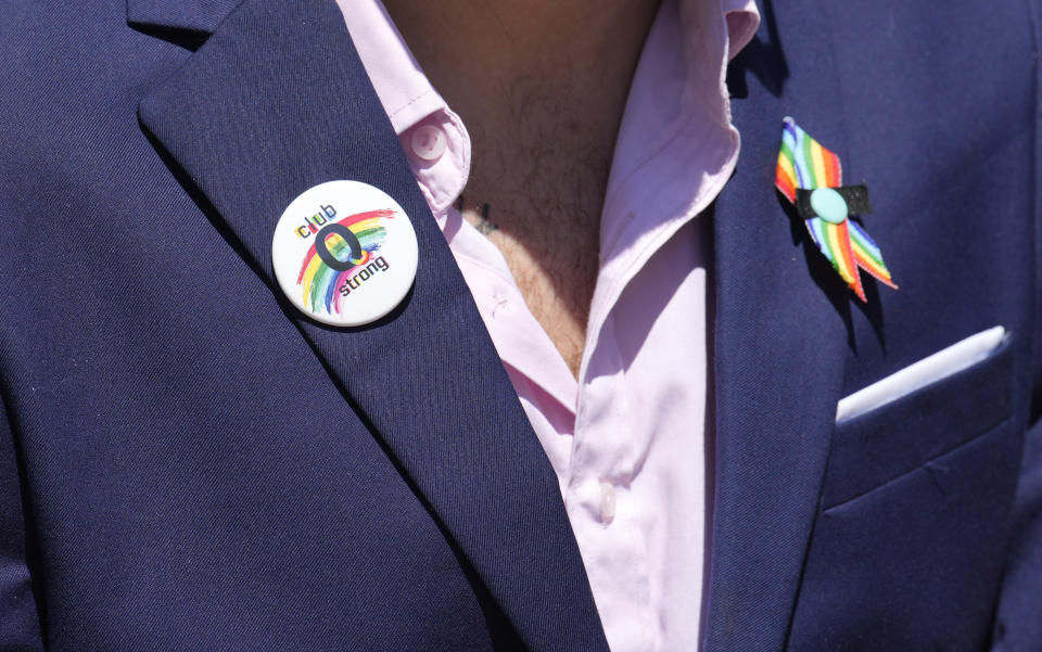 Michael Anderson, vice president of operations for Club Q, wears a button of support after a hearing for the suspect in a mass shooting at the gay nightclub Monday, June 26, 2023, in Colorado Springs, Colo. The suspect pleaded guilty in the attack that left five people dead and wounded multiple others just before Thanksgiving Day 2022, at the longtime sanctuary for the LGBTQ+ community in this mostly conservative city. (AP Photo/David Zalubowski)