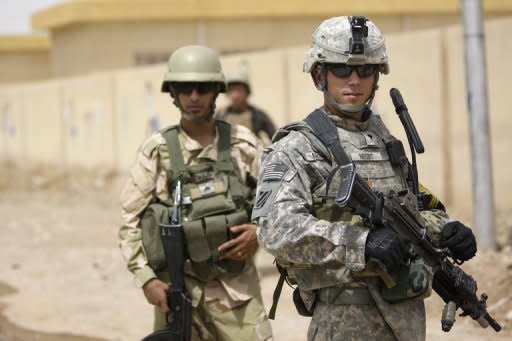 A US soldier (R) is seen on patrol with his Iraqi counterparts in northern Iraq. It is unclear whether paychecks would be delayed for service personnel, including the more than 140,000 troops in Afghanistan and Iraq, as a result of a political battle over budget cuts in Washington