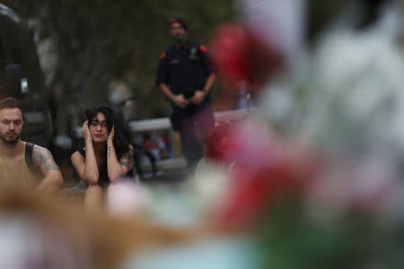 People gather at an impromptu memorial where a van crashed into pedestrians at Las Ramblas in Barcelona, Spain, August 20, 2017. REUTERS/Susana Vera