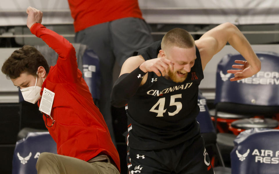 Cincinnati guard Mason Madsen (45) celebrates following Cincinnati's win over Wichita State after an NCAA college basketball game in the semifinal round of the American Athletic Conference men's tournament Saturday, March 13, 2021, in Fort Worth, Texas. (AP Photo/Ron Jenkins)