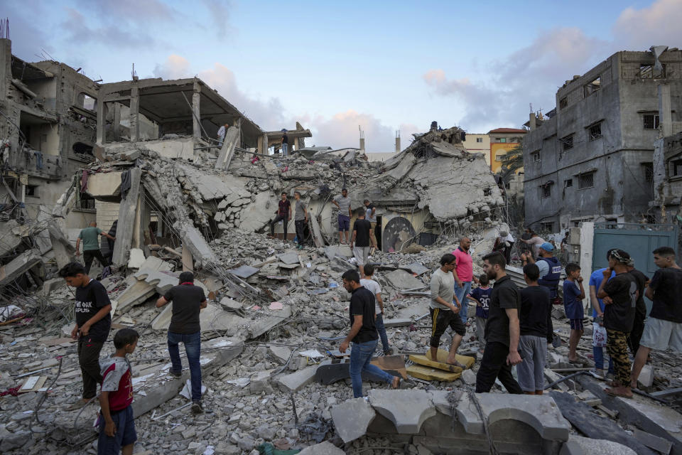 Palestinians look at the destruction after an Israeli airstrike in Deir al Balah, Gaza Strip, Tuesday, April 30, 2024. (AP Photo/Abdel Kareem Hana)