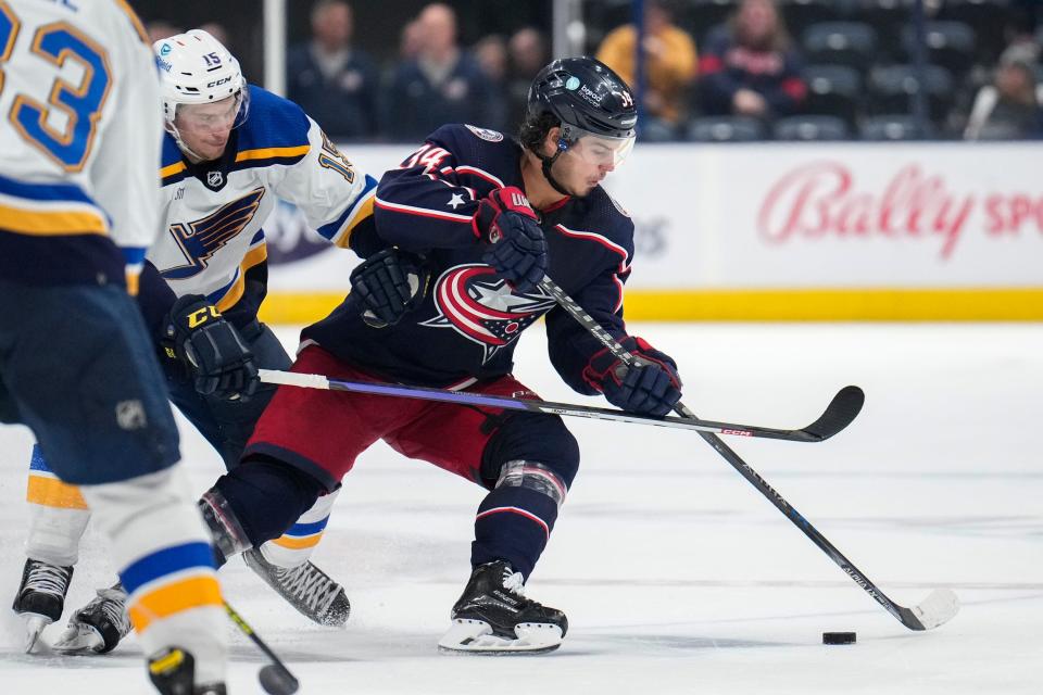 Oct 6, 2022; Columbus, Ohio, United States; Columbus Blue Jackets forward Cole Sillinger (34) contests the puck with St. Louis Blues forward Matthew Highmore (15) during the third period of the preseason game at Nationwide Arena. Mandatory Credit: Joseph Scheller-The Columbus Dispatch 