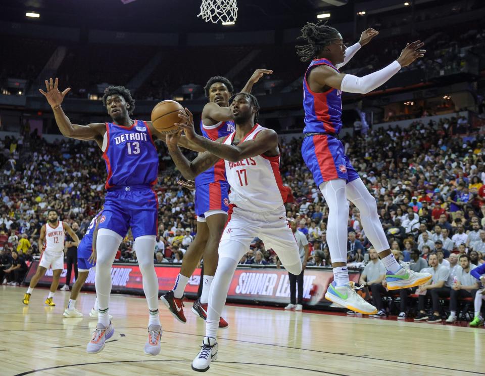 Rockets forward Tari Eason passes under pressure from the Pistons' James Wiseman, left,  Ausar Thompson and Jaden Ivey in the first half of the 133-101 loss to the Rockets in the NBA Summer League on Sunday, July 9, 2023, in Las Vegas.