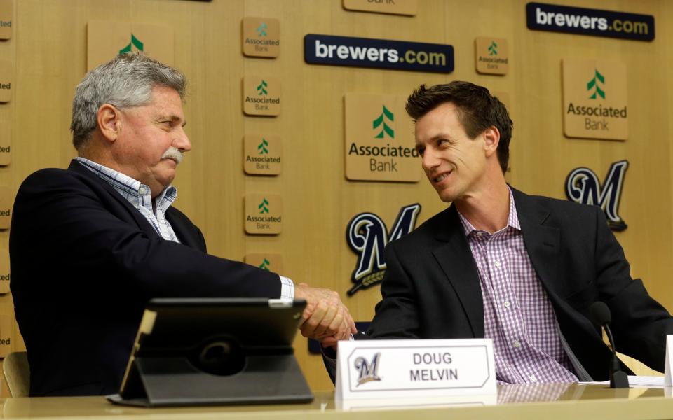 Craig Counsell shakes hands with then-general manager Doug Melvin at a news conference on May 4, 2015, in Milwaukee, after being introduced as the new Brewers manager. Counsell is the longest tenured manager in baseball and is the winningest in franchise history.