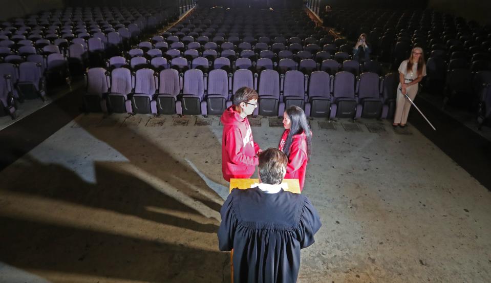 Joshua Migden and Jermarie Barrientos of Columbus are married by Akron Municipal Court Judge Ron Cable on Wednesday, May 4, 2022 in Akron, at the Highland Theater.