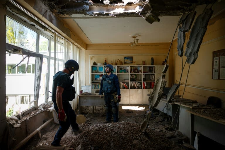 One rocket punched a hole in the roof of a school in Kharkiv, blowing out the windows (AFP/Dimitar DILKOFF)