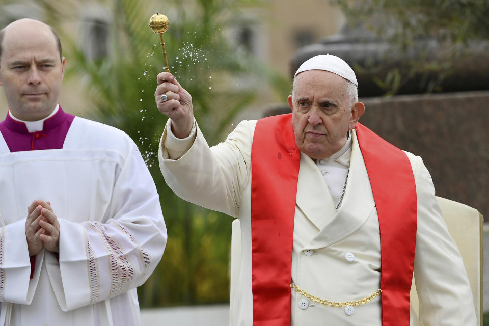 Pope Francis blesses faithful with olive and palm branches before celebrating the Palm Sunday's mass in St. Peter's Square at The Vatican Sunday, April 2, 2023 a day after being discharged from the Agostino Gemelli University Hospital in Rome, where he has been treated for bronchitis, The Vatican said. The Roman Catholic Church enters Holy Week, retracing the story of the crucifixion of Jesus and his resurrection three days later on Easter Sunday. (AP Photo/Filippo Monteforte, pool)