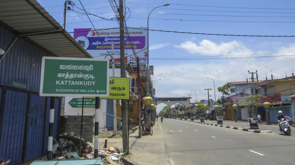 Light traffic moves down a street in Kattankudy, a Muslim-majority town in the eastern province of Sri Lanka, Sunday, Sept. 5, 2021. Kattankudy is the home town of Ahamed Aathil Mohamed Samsudeen, an Islamic State-inspired extremist who attacked shoppers in a New Zealand supermarket on Friday, Sept. 3, 2021. (AP Photo/Kanagarasa Saravanan)