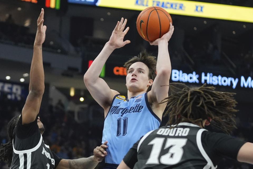 Marquette's Tyler Kolek shoots between Providence's Josh Oduro and Corey Floyd Jr. during the first half of an NCAA college basketball game Wednesday, Feb. 28, 2024, in Milwaukee. (AP Photo/Morry Gash)