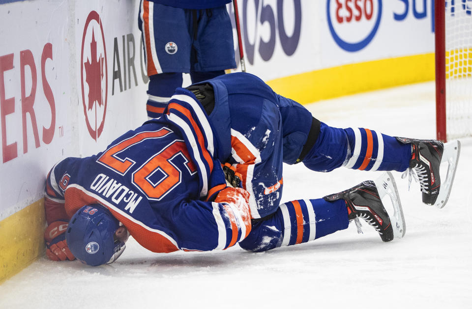 Edmonton Oilers' Connor McDavid (97) lies on the ice while playing against the Pittsburgh Penguins during second-period NHL hockey game action in Edmonton, Alberta, Monday, Oct. 24, 2022. (Jason Franson/The Canadian Press via AP)