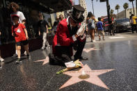 Fans honor actor Olivia Newton-John with flowers on her Hollywood Walk of Fame star in Los Angeles, Monday, Aug. 8, 2022. Olivia Newton-John, the Grammy-winning superstar who reigned on pop, country, adult contemporary and dance charts with such hits as "Physical" and "You're the One That I Want" has died. She was 73. (AP Photo/Damian Dovarganes)