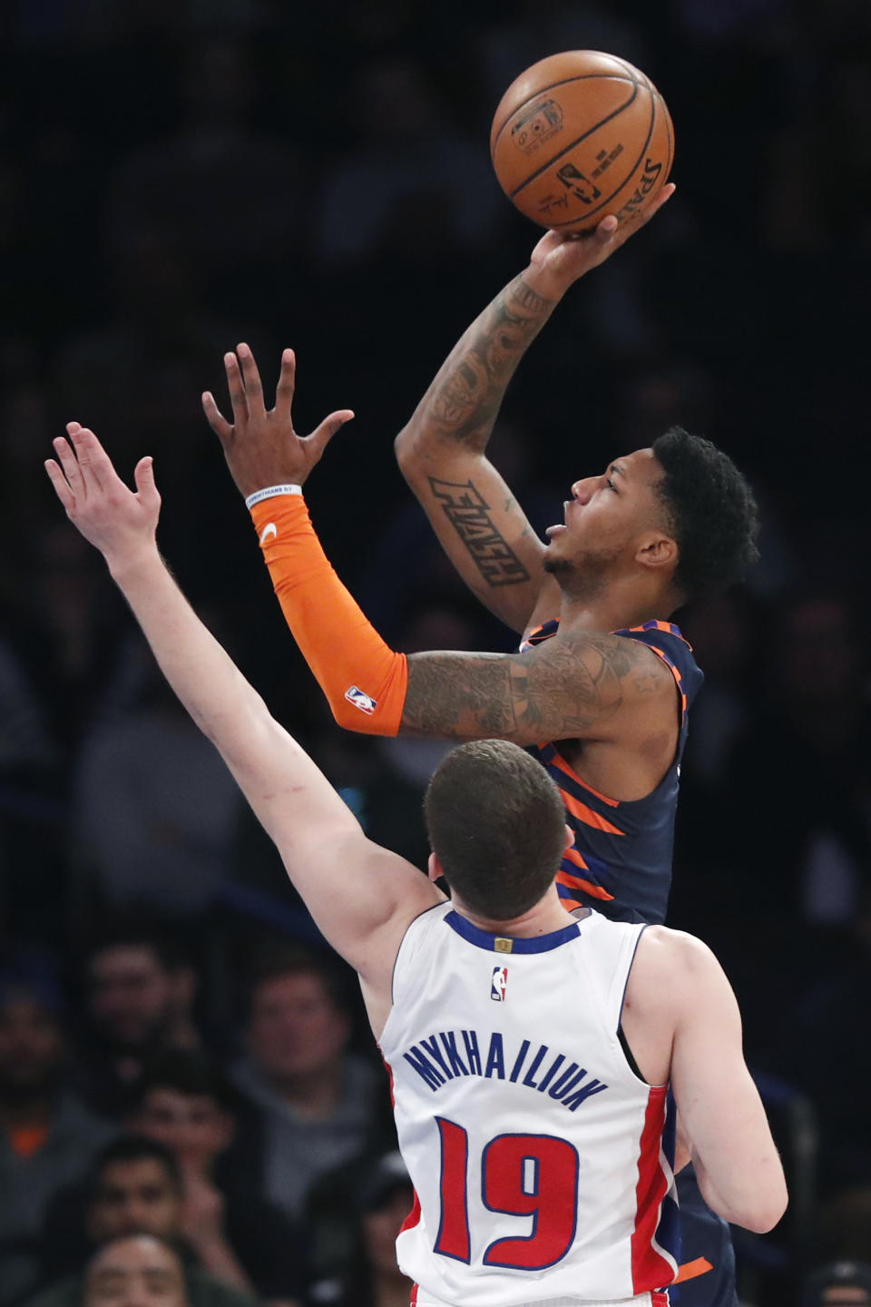 New York Knicks guard Elfrid Payton, right, shoots with Detroit Pistons guard Sviatoslav Mykhailiuk (19) defending during the first half of an NBA basketball game in New York, Sunday, March 8, 2020. (AP Photo/Kathy Willens)