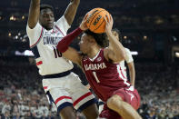 Alabama guard Mark Sears (1) drives as UConn guard Hassan Diarra (10) defends during the second half of the NCAA college basketball game at the Final Four, Saturday, April 6, 2024, in Glendale, Ariz. (AP Photo/Brynn Anderson )