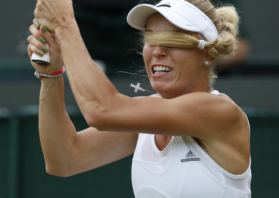 RNPS YEAR END 2014 - BEST OF SPORT ODDLY Caroline Wozniacki of Denmark hits a return to Naomi Broady of Britain during their women's singles tennis match at the Wimbledon Tennis Championships, in London, in this June 25, 2014 file photo. REUTERS/Suzanne Plunkett/Files (BRITAIN - Tags: SPORT TENNIS TPX IMAGES OF THE DAY)