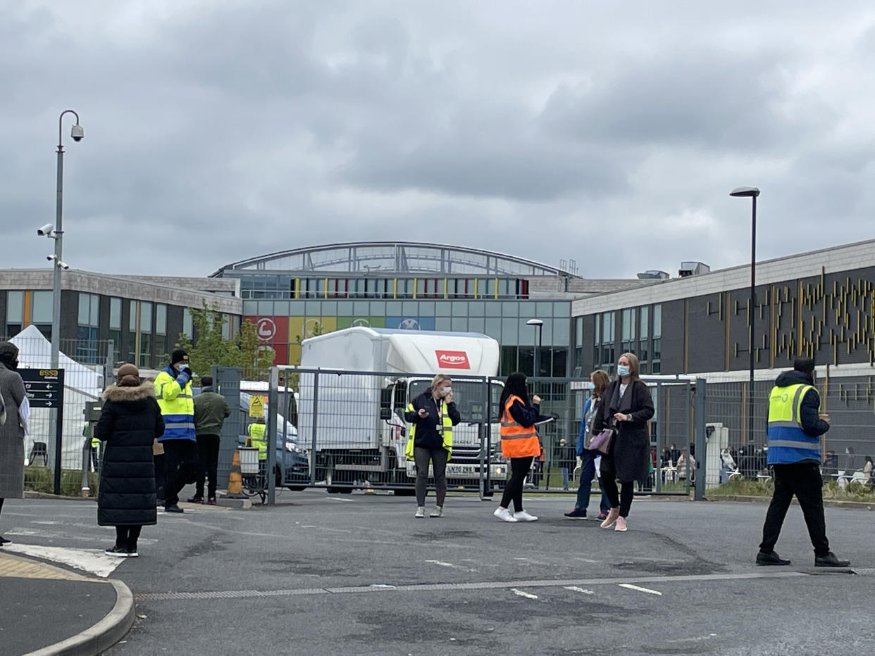 People queue for the vaccination centre at the Essa Academy in Bolton. The Indian coronavirus variant has been detected in a number of areas in England, including Bolton, which are reporting the highest rates of infection, data suggests. Picture date: Friday May 14, 2021.