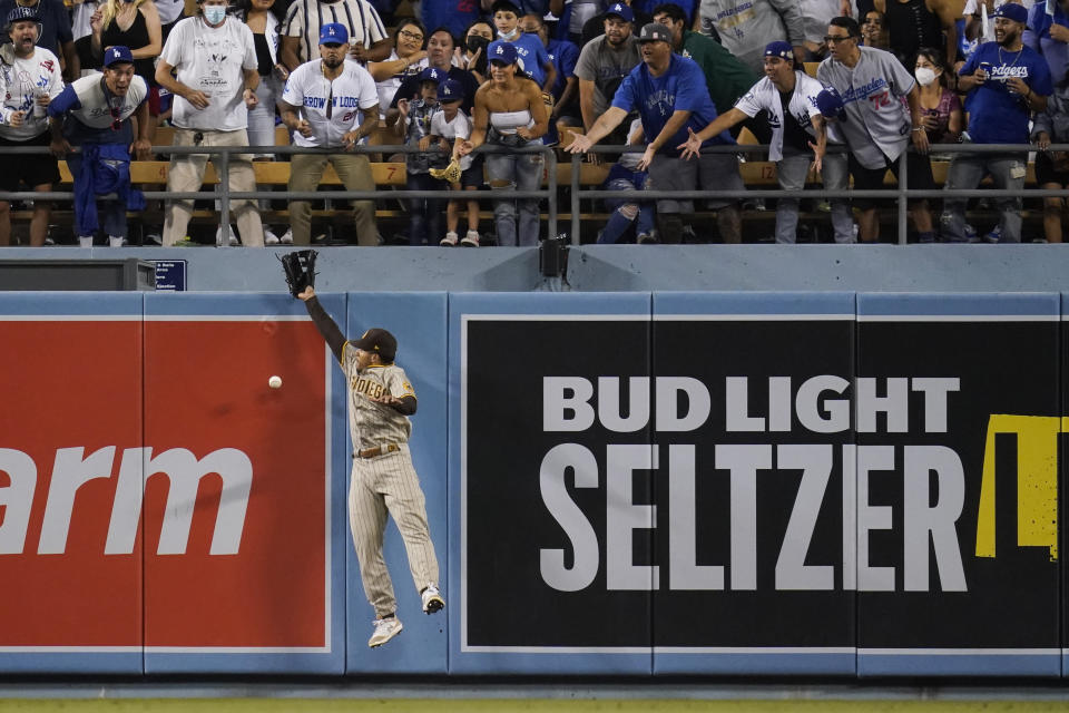 San Diego Padres center fielder Trent Grisham misses a fly ball hit by Los Angeles Dodgers' Will Smith during the fourth inning of a baseball game Friday, Sept. 10, 2021, in Los Angeles. (AP Photo/Ashley Landis)