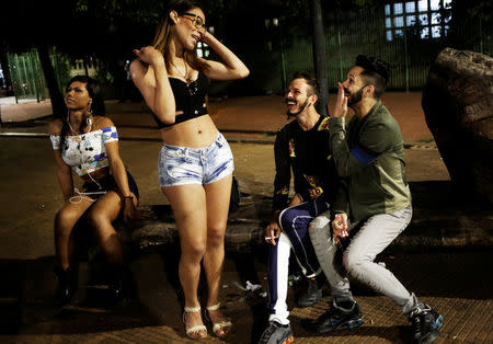 Jorge (2nd R), 31, who is among members of lesbian, gay, bisexual and transgender (LGBT) community and his brother Paulo, 28, (R) laugh at Arouche Square in downtown Sao Paulo, Brazil, November 20, 2016. REUTERS/Nacho Doce