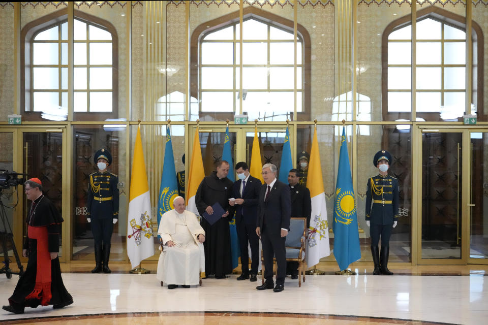 Pope Francis, left, meets the Kazakhstan's President Kassym-Jomart Tokayev as he arrives at Our-Sultan's International airport in Nur-Sultan, Kazakhstan, Tuesday, Sept. 13, 2022. Pope Francis begins a 3-days visit to the majority-Muslim former Soviet republic to minister to its tiny Catholic community and participate in a Kazakh-sponsored conference of world religious leaders. (AP Photo/Andrew Medichini)