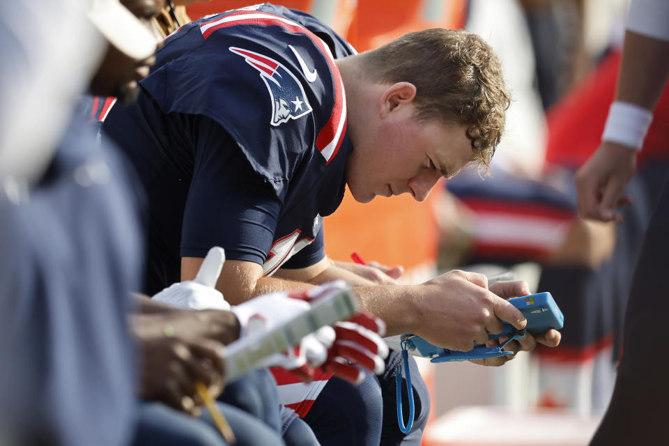 New England Patriots quarterback Mac Jones sits on the bench in the first half of an NFL football game against the Washington Commanders, Sunday, Nov. 5, 2023, in Foxborough, Mass. (AP Photo/Michael Dwyer)