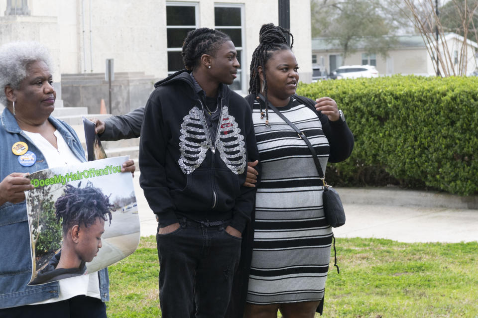 Darryl George, center, waits with his mother Darresha before a hearing regarding George's punishment for violating school dress code policy because of his hair style, Thursday Feb. 22, 2024 at the Chambers County Courthouse in Anahuac, Texas. A judge has ruled that George's monthslong punishment by his Texas school district for refusing to change his hairstyle does not violate a new state law prohibiting race-based hair discrimination. (Education Hair-Discrimination/Houston Chronicle via AP)