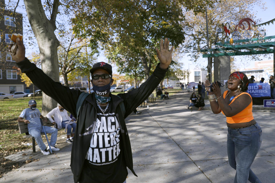 FILE - A man wears a shirt that says, "Black voters matter," while dancing, Sunday, Nov. 8, 2020, in Fairhill Suare Park in Philadelphia, to celebrate after Democrat Joe Biden defeated President Donald Trump to become 46th president of the United States. (AP Photo/Rebecca Blackwell, File)