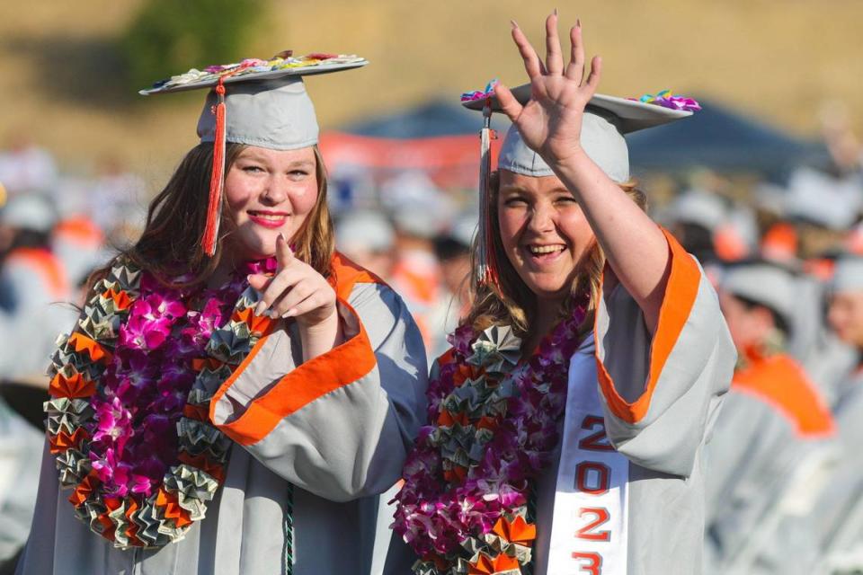 Makenna Dayton, left and Rachel Livermore wave to friends and family. Atascadero held their 102nd commencement ceremony on June 8, 2023.