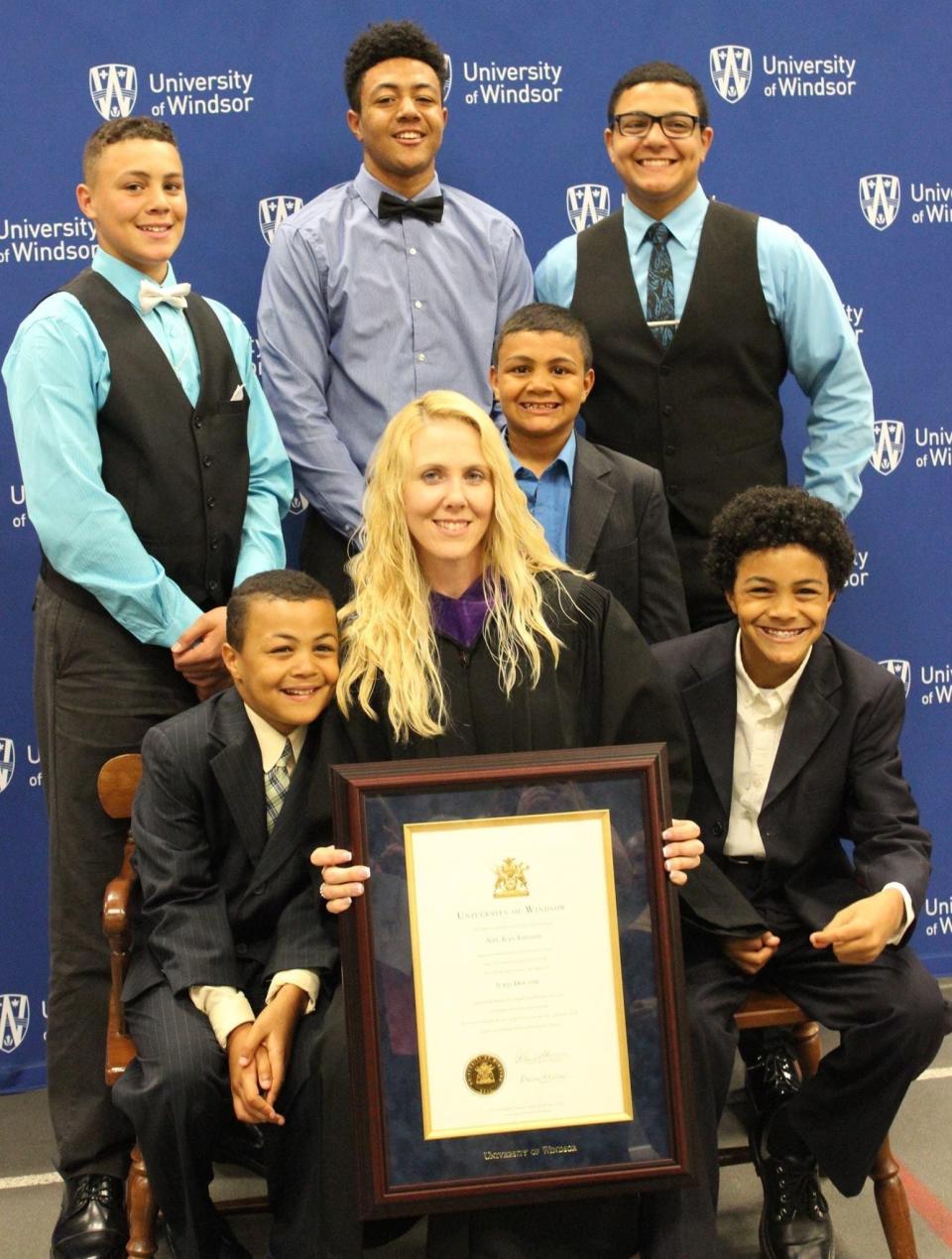 Amy Johnson, center, earned undergraduate and law degrees while raising six boys, including future Penn State star tight end Theo Johnson (top, left). She did that after they escaped from a dangerous abuse situation at home. Theo's brothers are Dominic (top, middle), Nathan (top, right), Michael (bottom, left), Michael (Levi, right) and Keon.