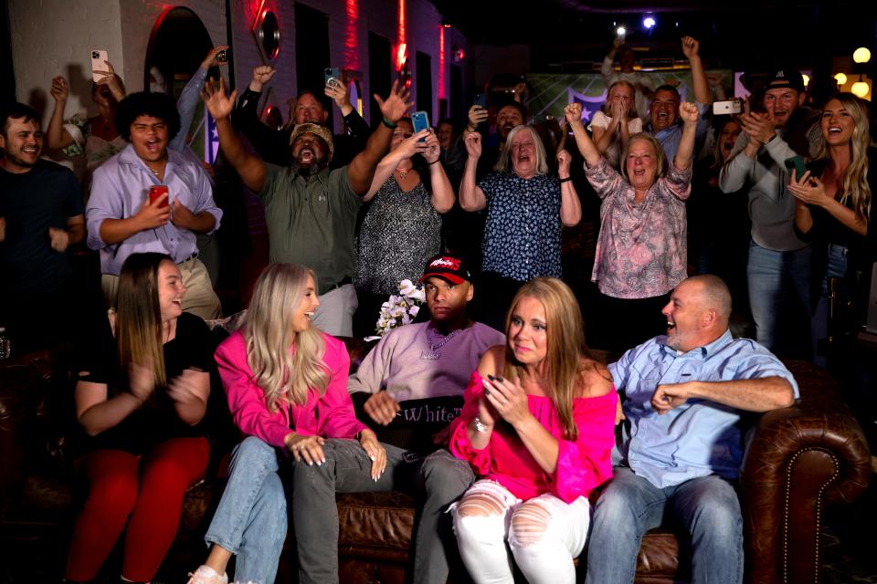 Desmond Ridder, former UC quarterback, center, reacts with friends and family to his selection by the Atlanta Falcons being officially read on the 2022 NFL Draft broadcast in the third round at his draft party in Louisville, Ky., on Friday, April 29, 2022. "Thank God for putting me in this opportunity, putting me in this position to go do something great," Ridder said. 