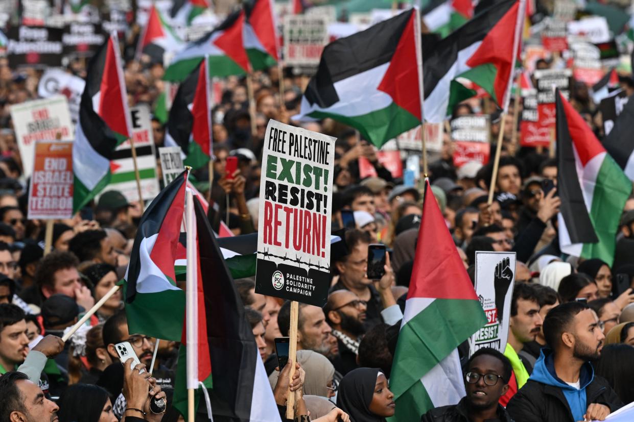 Protsters carry placards and Palestinian flags along Whitehall during a 'March For Palestine', part of a pro-Palestinian national demonstration, in London on October 14, 2023, organised by Palestine Solidarity Campaign, Friends of Al-Aqsa, Stop the War Coalition, Muslim Association of Britain, Palestinian Forum in Britain and CND. British Prime Minister Rishi Sunak called on Israel Friday to take 