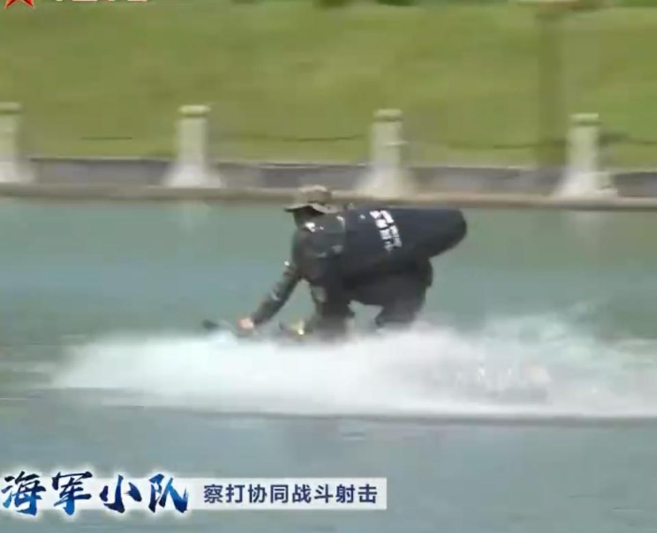 A Chinese naval commando rides a jet surfboard at a military academy.