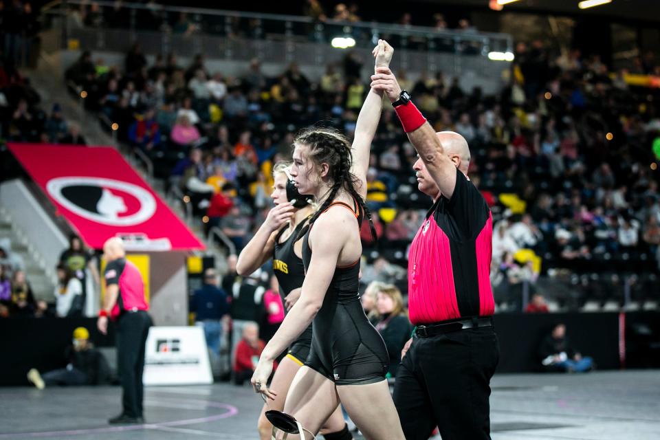 Ames' Alexis Winkey has her hand raised after scoring a fall at 125 pounds during the IGHSAU state girls wrestling tournament.