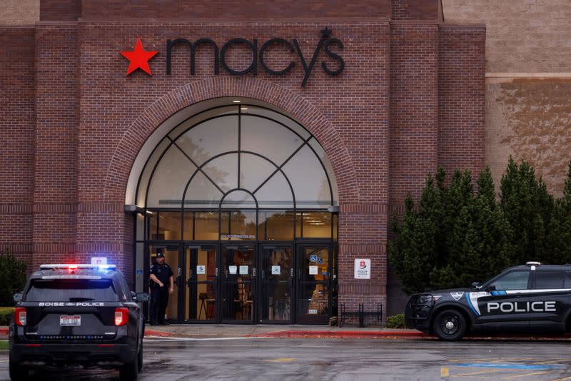 Boise Police Department vehicles sit parked at the scene of a shooting at the Boise Towne Square shopping mall in Boise, Idaho