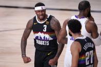 Denver Nuggets' Torrey Craig (3) and Jamal Murray (27) celebrate a dunk by Murray as Los Angeles Lakers' LeBron James, right walks past during the second half of Game 3 of the NBA basketball Western Conference final, Tuesday, Sept. 22, 2020, in Lake Buena Vista, Fla. (AP Photo/Mark J. Terrill)