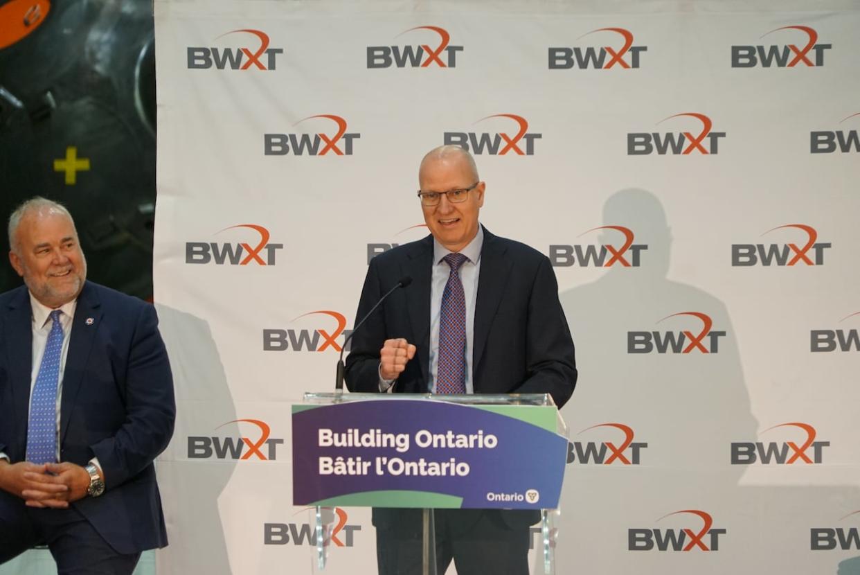 President of commercial operations at BWXT, John MacQuarrie, presents beside Ontario Energy Minister Todd Smith at a press conference inside his Cambridge nuclear manufacturing facility. (Cameron Mahler/CBC - image credit)