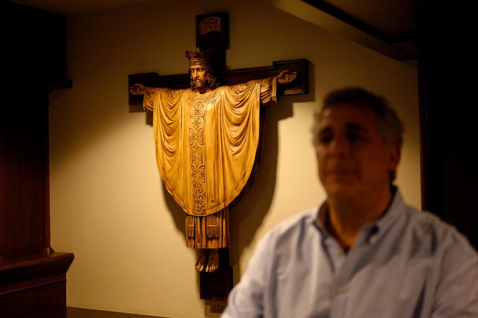 A crucifix hangs behind Rabbi in Residence Aaron Bisno at Calvary Episcopal church on Thursday, Oct. 26, 2023, in Pittsburgh's Shadyside neighborhood.