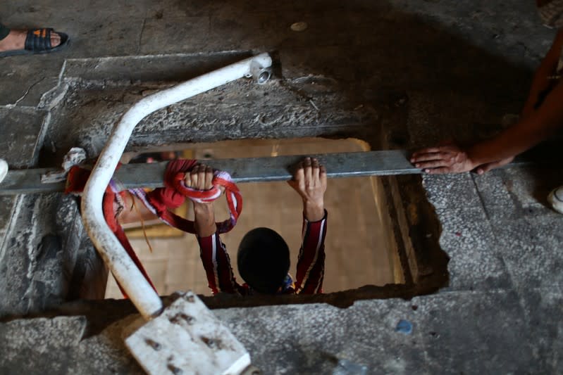 Iraqi demonstrators move inside the high-rise building, called by Iraqi the Turkish Restaurant Building, during anti-government protests in Baghdad