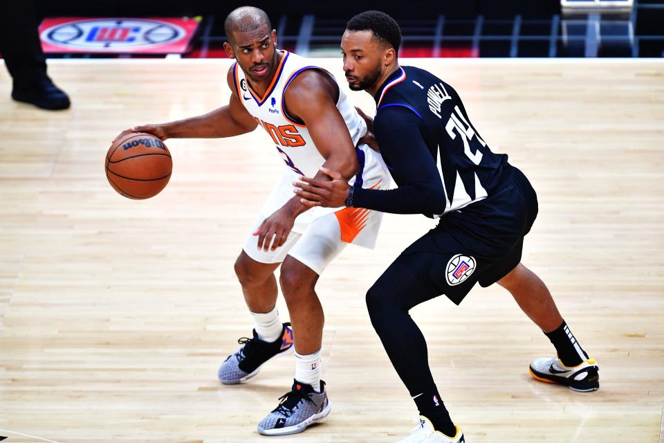 Phoenix Suns guard Chris Paul (3) flicks the ball against Los Angeles Clippers guard Norman Powell (24) during the second half in Game 4 of the 2023 NBA Playoffs at Crypto.com Arena on April 22, 2023.