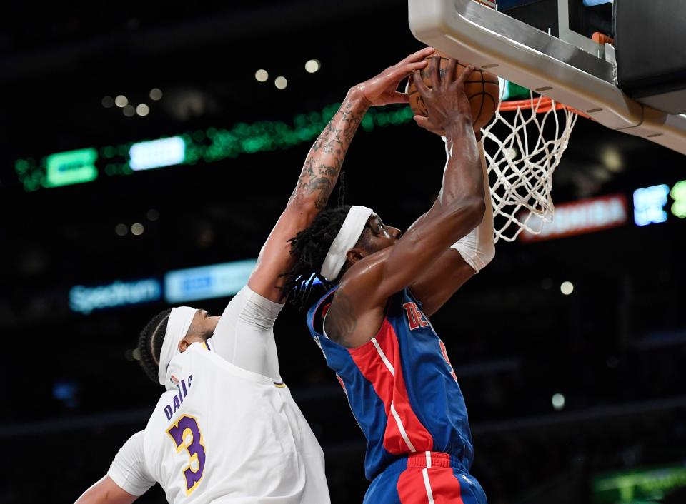 Lakers forward Anthony Davis blocks a layup by Pistons forward Jerami Grant in the first half on Sunday, Nov. 28, 2021, in Los Angeles.