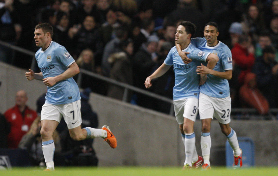 Manchester City's Samir Nasri, centre, celebrates after scoring the second goal of the game against Chelsea during their English FA Cup fifth round soccer match at the Etihad Stadium, Manchester, England, Saturday, Feb. 15, 2014. (AP Photo/Jon Super)