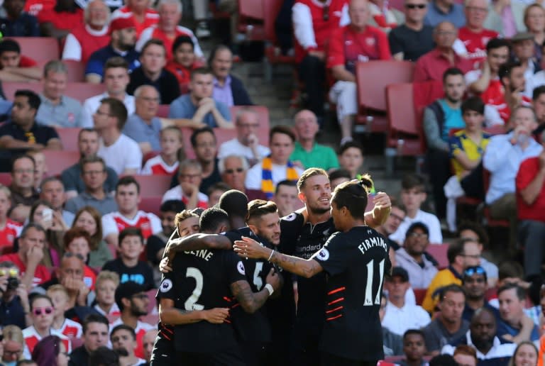 Liverpool players celebrate their first goal scored by midfielder Philippe Coutinho against Arsenal on August 14, 2016