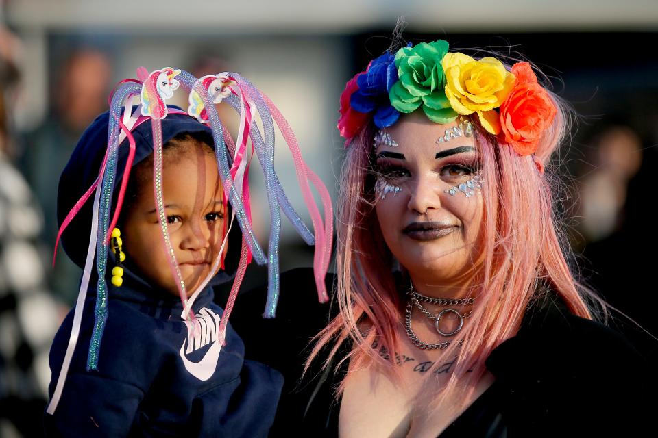 Jordan Williams holds Dahlani McCullum as they listen to music April 28, 2022, during the Norman Music Festival.