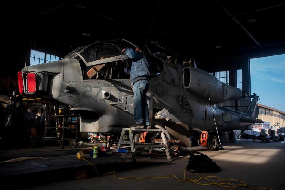 United States Air Force veteran Marcelo Paz, 69, of Chowchilla, works on a Bell AH-1W Cobra attack helicopter inside Castle Air Museum’s restoration hanger in Atwater, Calif., on Wednesday, Jan. 12, 2022. According to Castle Air Museum Chief Executive Director Joe Pruzzo, the Bell AH-1W Cobra attack helicopter and a SH-60B Seahawk helicopter were acquired from Hawaii in 2021. When ready, the aircraft will be displayed on the Castle Air Museum grounds along with dozens of other vintage aircraft.