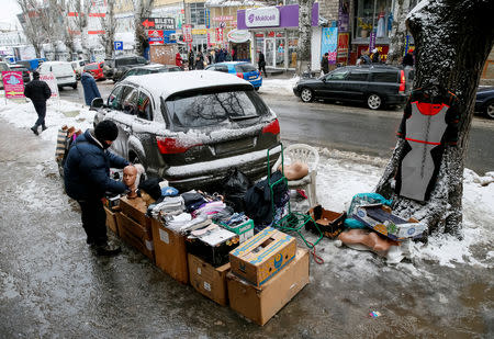 A street vendor sells clothes in central Chisinau, Moldova January 21, 2019. Picture taken January 21, 2019. REUTERS/Gleb Garanich
