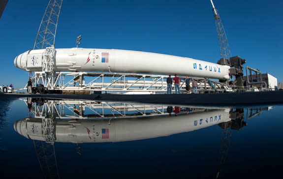 SpaceX's Falcon 9 rocket and Dragon capsule roll out from the hangar for the CRS-2 launch to the International Space Station to deliver NASA cargo in March 2013.