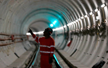 FILE PHOTO: A worker stands on the railway track in a tunnel of the Crossrail project in Stepney, east London, Britain, November 16, 2016. REUTERS/Stefan Wermuth/File Photo