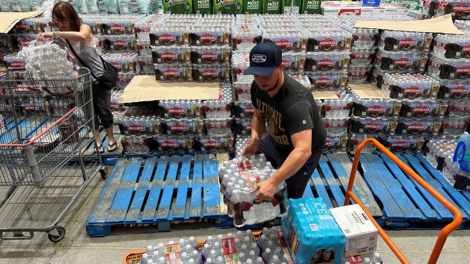 An Instacart delivery driver loads cases of bottled water as people buy emergency supplies ahead of Hurricane Hilary at a Costco warehouse in Hawthorne, California, on August 19, 2023. - David Swanson/AFP/Getty Images