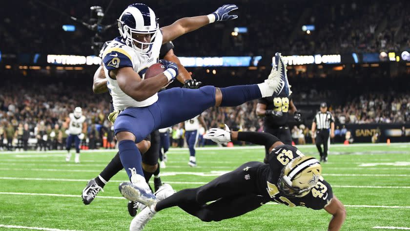 NEW ORLEANS, LOUISIANA, NOVEMBER 4, 2018-Rams running back Malcolm Brown leaps over Saints safety Ma