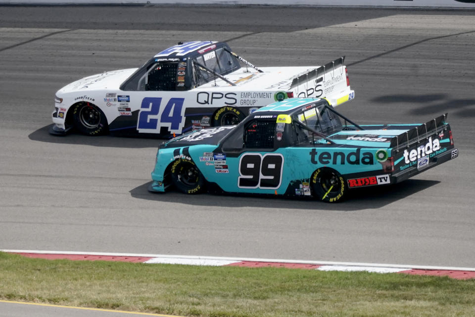 Sam Mayer (24) leads Ben Rhodes (99) out of Turn 2 during a NASCAR Truck Series race at World Wide Technology Raceway on Sunday, Aug. 30, 2020, in Madison, Ill. (AP Photo/Jeff Roberson)