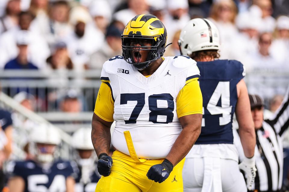 Kenneth Grant of the Michigan Wolverines celebrates after a play against the Penn State Nittany Lions during the first half at Beaver Stadium on November 11, 2023 in State College, Pennsylvania.