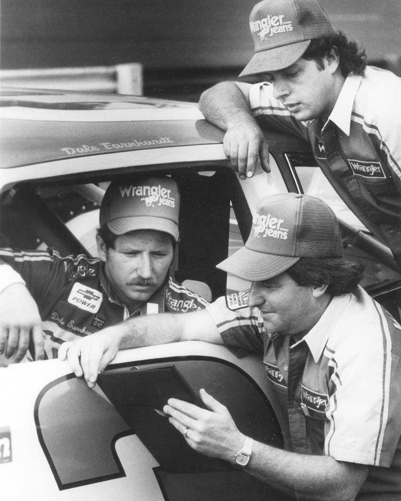 Richard Childress shows his notes to driver Dale Earnhardt and crew chief Kirk Shelmerdine